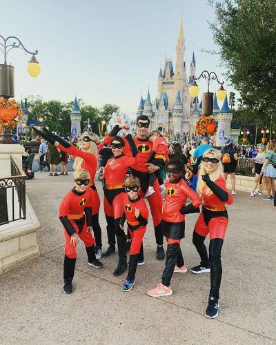 Picture of Heidi Strobel on Disney land with her husband, kids and sisters on her 41th birthday.